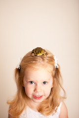 Happy Little Princess Girl with a Frog on Her Head