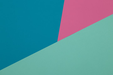 Blue, green and pink background, colored paper geometrically divides into zones, frame, copy, space.