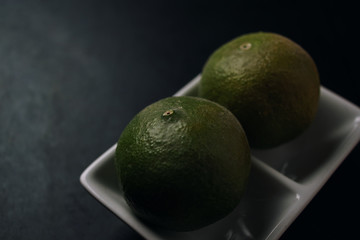 Green lime in a white plate