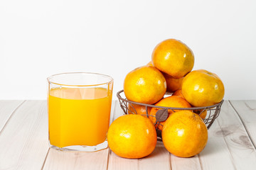 Glass of fresh orange juice on wooden background with copy space