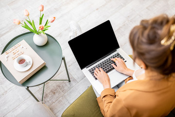 Woman working on computer at home, laptop with black screen to copy paste, view from above. Concept...