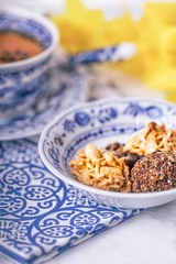 Homemade peanut and chocolate cookie and cup of tea. White and blue dishes