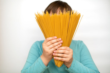 The child is holding traditional Italian spaghetti with a fan in place of the face. Creative idea.