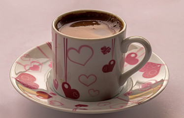 Turkish coffee in a cup over white background.
