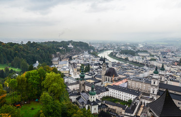 Panoramic view of Salzburg with Salzach river and Mirabell Garden from Festung Hohensalzburg in cloudy rainy day. Austria