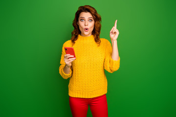 Portrait of astonished woman raise index finger up decide what text type scream wow omg use smartphone wear style stylish jumper pants isolated over bright shine color background