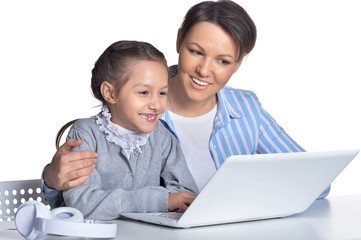Portrait of emotional mother and daughter using laptop