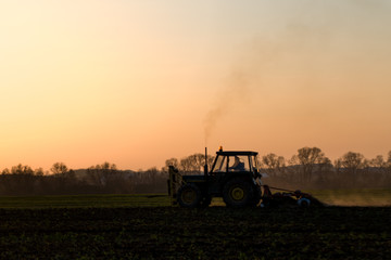 tractor farming sunset