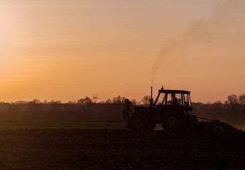 tractor farming sunset