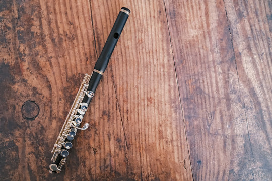 Top down view of classic wooden flute on a hardwood background with copy space