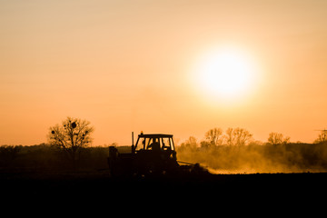Fototapeta premium tractor farming sunset