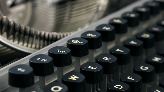 Side view footage of all keyboard and keys with letters of an old and vintage typewriter, selective focus