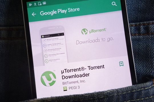 KONSKIE, POLAND - JUNE 02, 2018: uTorrent app on Google Play Store website displayed on smartphone hidden in jeans pocket