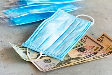 Medical mask equivalent to a monetary unit. Pandemic virus COVID-19.Antiviral medical mask for protection against flu diseases. Surgical mask. Crisis and finance concept,stay at home, Coronavirus 