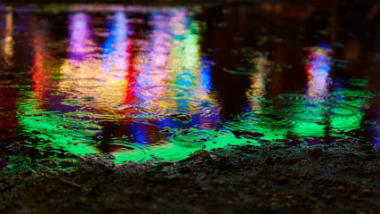 Colorful colors reflect in puddle when it rains