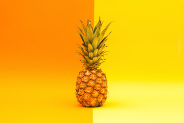 Fresh pineapple on an orange and yellow background