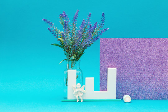 Letter object with lavender and angel object with a shiny purple and blue background
