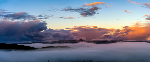 Fototapeta na wymiar Panorama of Sunrise, Fog, Mountains