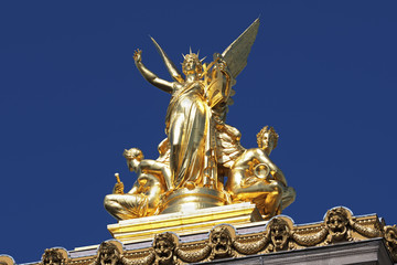 Fototapeta na wymiar Gilded figural group L'Harmonie atop the Palais Garnier in Paris