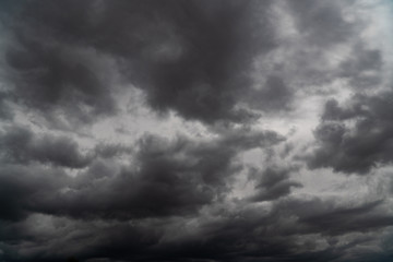 Obraz premium Storm is coming. Before heavy rain storm. On the sky is covered all over by the clouds. A lot of lightning and strong wind. The dark clouds is look like a big black smoke from erupting volcano