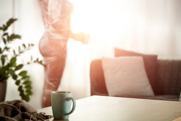 A woman at the table in the glow of the morning light