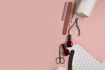 Tools for manicure on a beige background. Nail files, scissors and nail polishes top view. Nail...