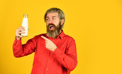 bearded man drink useful milk. healthy food and drink. Non dairy coconut vegan milk in glass. try almond milk. Cream liquid of dairy drink. happy farmer present milk glass. copy space