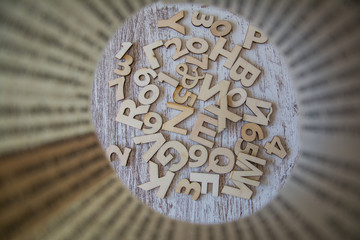 Letters and numbers of woods on a light wooden background