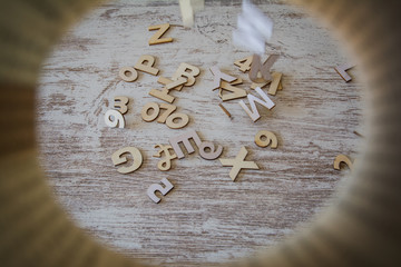 Wooden letters and numbers falling from above.