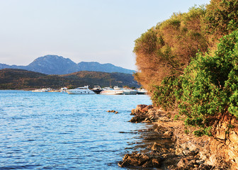Sunrise with yachts on at Mediterranean sea Sardinia