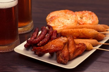 Beer glass alcohol drink with food sausage, snack pub.