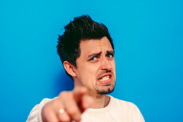 Young man showing his index finger towards the camera