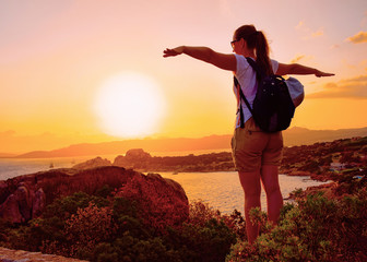 Sunrise or sunset and young lady at Baja Sardinia reflex