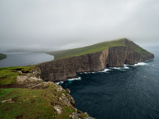 Fototapeta na wymiar Faroe Islands. Trælanípan. View form Slave Cliffs on the lake Leitisvatn hanging over the ocean.