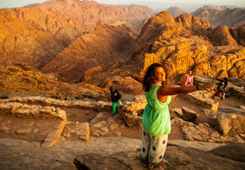Woman feeling good on mountain trek adventure watching sunrise, SInai, Egypt, Africa