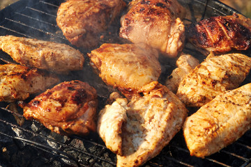 Chiken barbeque on a grill roasting open fire spring summer time