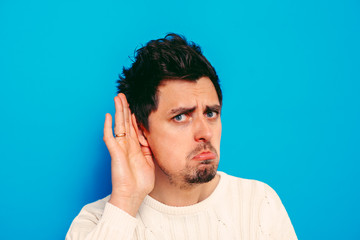 Overhears a man, tries to listen.