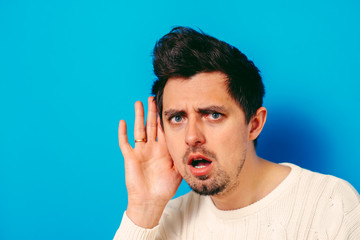 Overhears a man, tries to listen.