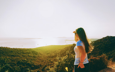 Young girl looking sunrise in resort Mediterranean sea reflex