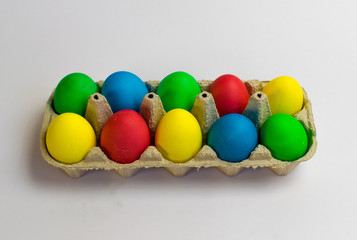Fototapeta na wymiar Colored eggs in a tray Easter is coming soon
