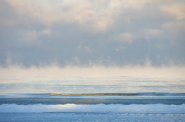 Sea smoke in winter. The Baltic Sea on a cold Janusry morning in Latvia. Steam fog.
