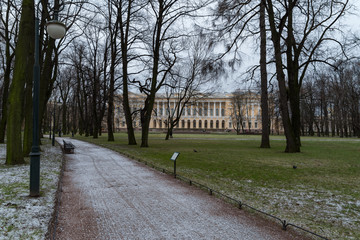 Alley in Mikhailovsky garden at winter with Russian Museum at background. Saint Petersburg, Russia.