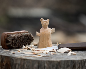 hand carved bear in a log, hand crafted artwork.