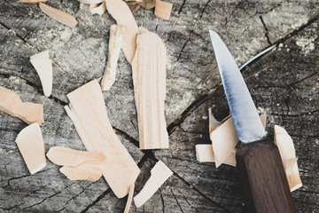 Carving knife and wood shavings or chips, hand crafting 