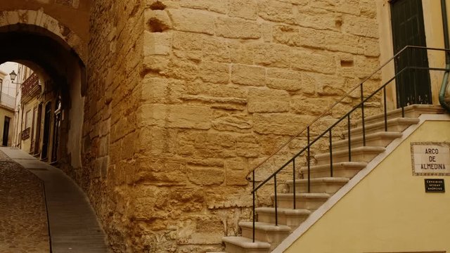 Crossing the medieval Arch of Almedina in Coimbra, Portugal, built in the 11th century, after the Christians reconquered the city