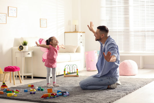 Father playing with his child at home