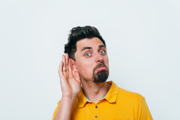 Overhears a man, tries to listen.