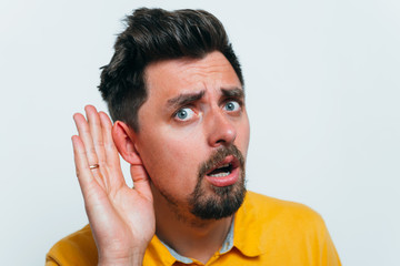 Overhears a man, tries to listen.