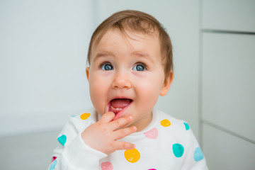 portrait of a child. Toddler girl smiles and looks into the camera