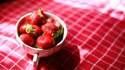 Group of strawberry in a white bowl, Strawberry in red background,